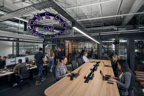 Freelancer working in a modern Australian coworking space with laptop, natural light and professional workspace setup