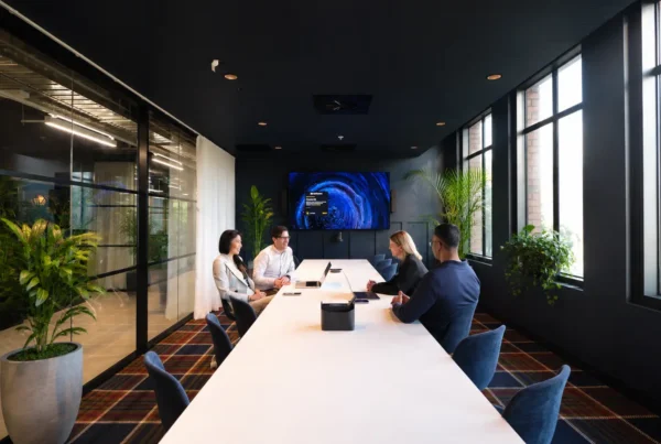 Small professional team using a technology-equipped meeting room within CreativeCubes.Co serviced private offices